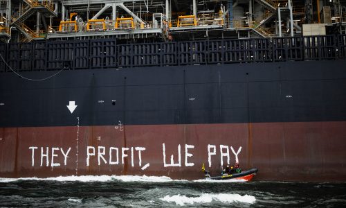 Greenpeace activists painting slogan on FPSO hull during Rosebank offshore oil protest