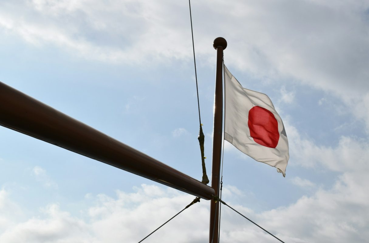 Illustrative flag at sea accompanying article on Japanese carriers halting Hormuz transits