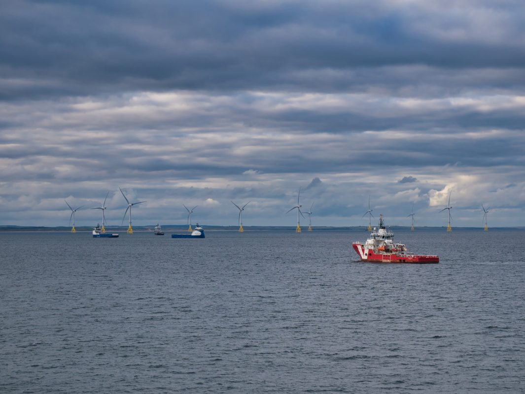 Offshore wind support vessels operating near wind turbines at a North Sea wind farm off Aberdeen, Scotland