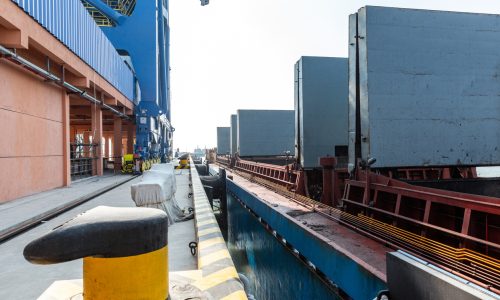 Cargo ships berthed at container port showing shipping delays and port control in global trade