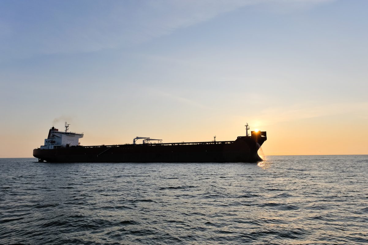 Crude oil tanker transporting cargo at sea amid global oil trade and sanctions on Russian crude