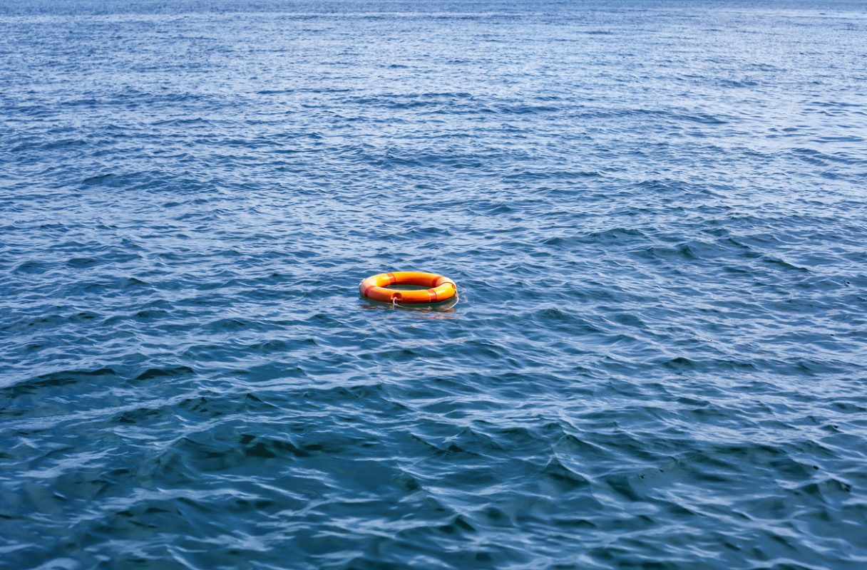 orange life buoy floating in the ocean representing maritime search and rescue