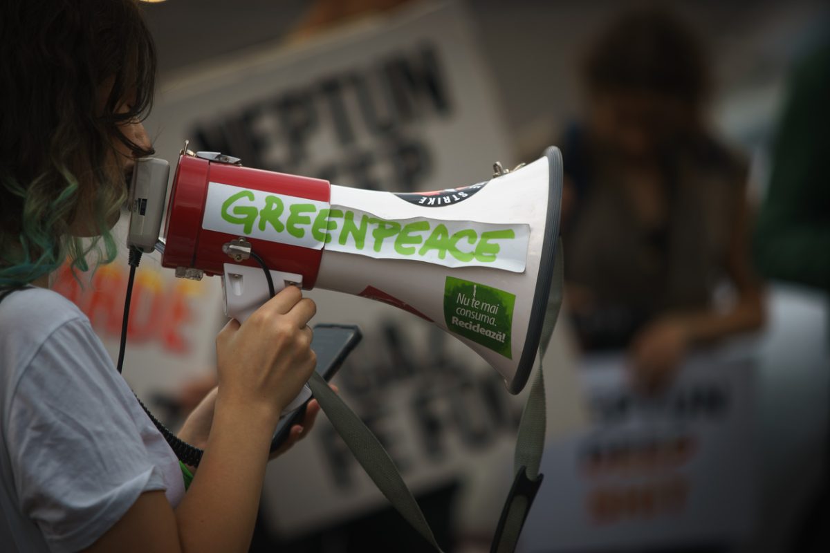Greenpeace protest display showing activists with banners