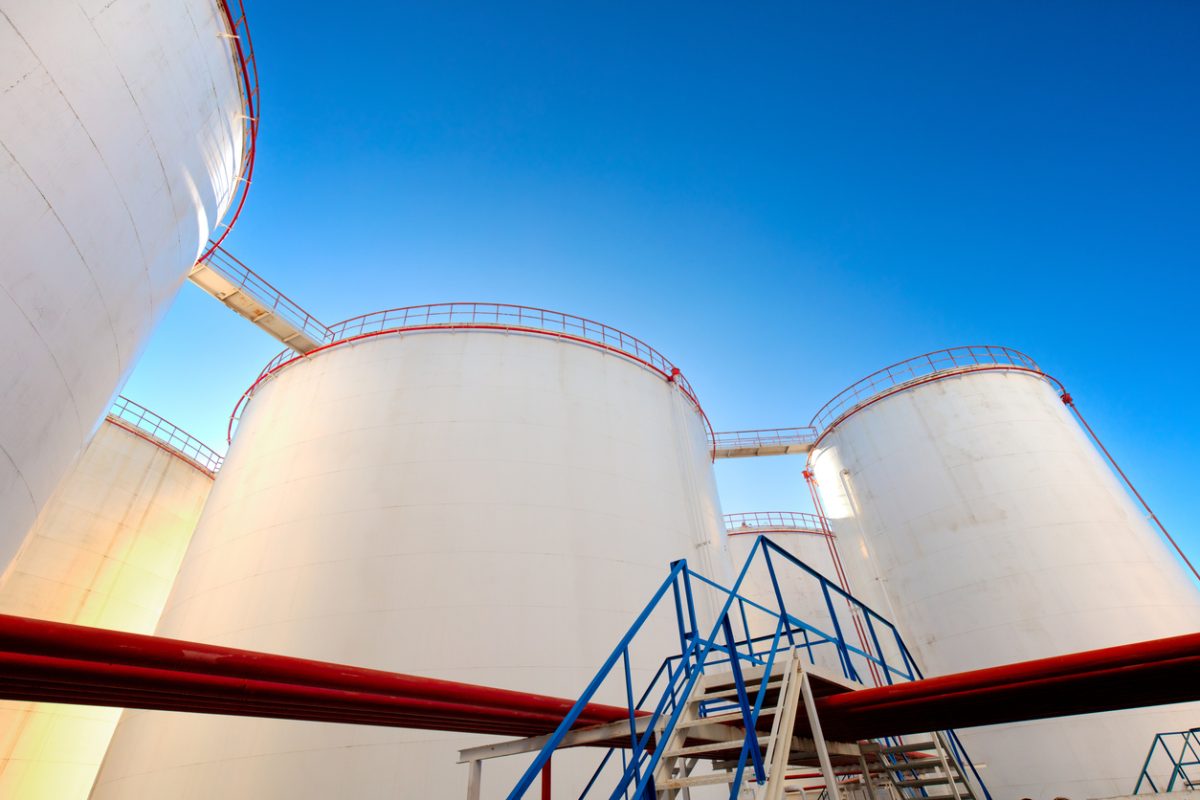 Oil storage tanks and pipelines at an industrial petroleum storage facility.
