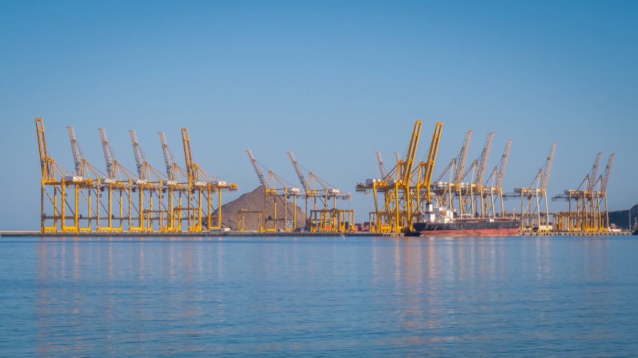 Port cranes loading a container ship at the Port of Fujairah UAE major Gulf shipping hub