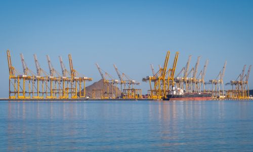 Port cranes loading a container ship at the Port of Fujairah UAE major Gulf shipping hub