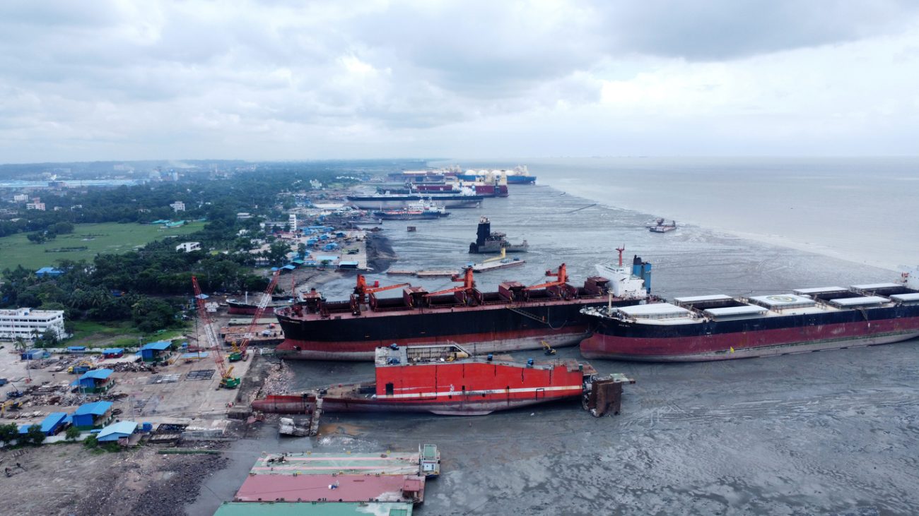 Ship recycling workers dismantling vessel at Bangladesh shipbreaking yard