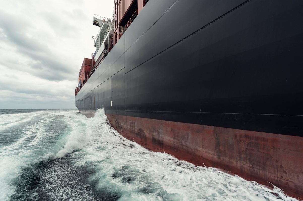 Container ship loaded with cargo containers sailing at sea on a global trade route.
