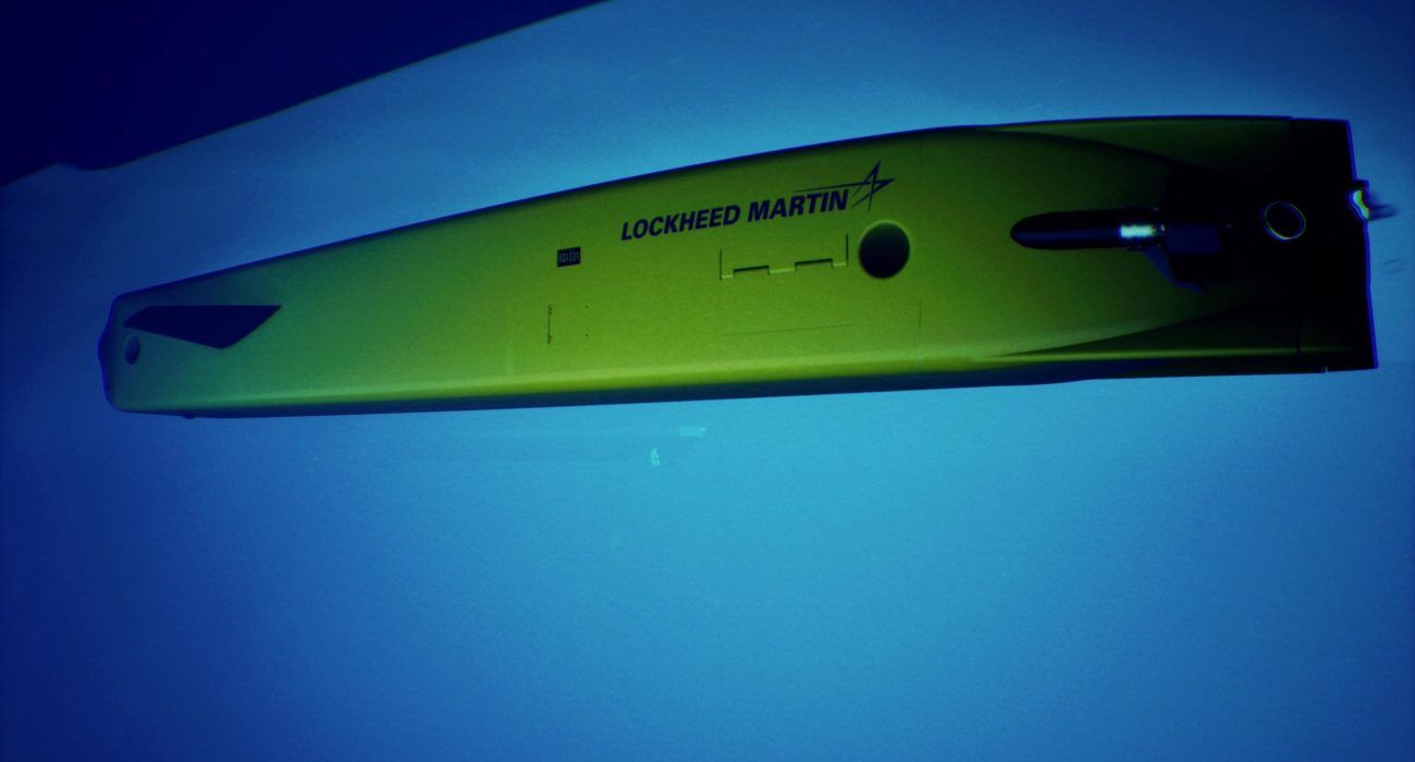 Lockheed Martin Lamprey autonomous undersea vehicle attaching to ship hull during deployment