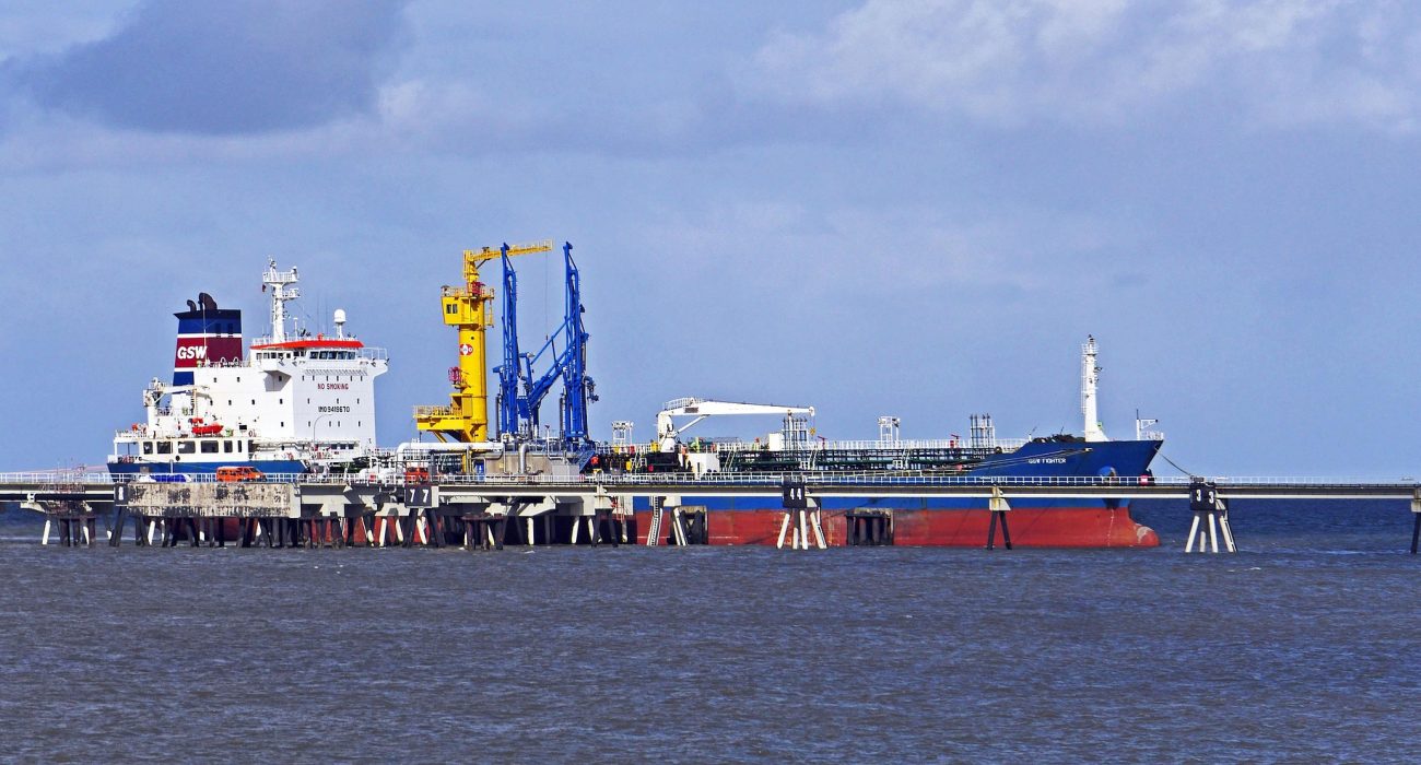 Representative oil tanker at port illustrating US sanctions on Iran linked tankers