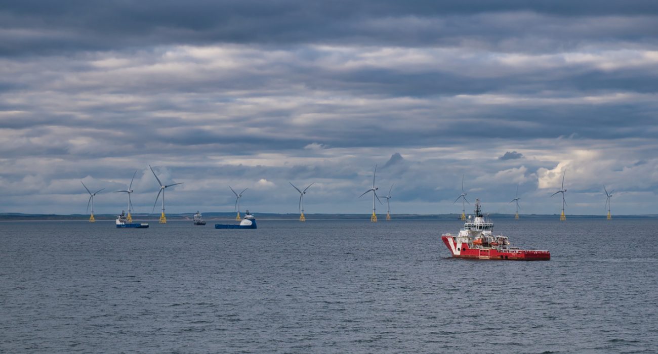 Offshore wind support vessels operating near wind turbines at a North Sea wind farm off Aberdeen, Scotland