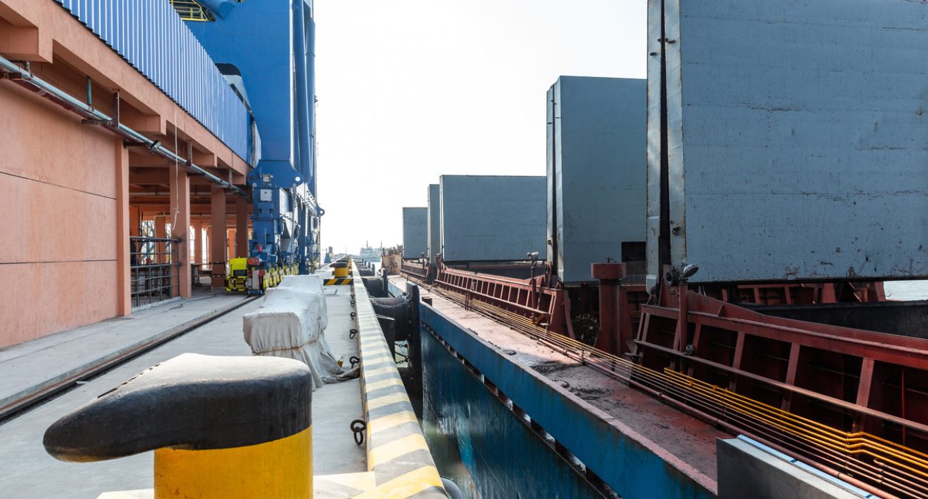 Cargo ships berthed at container port showing shipping delays and port control in global trade