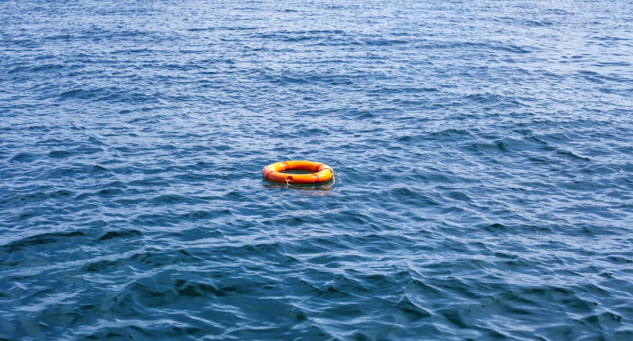 orange life buoy floating in the ocean representing maritime search and rescue