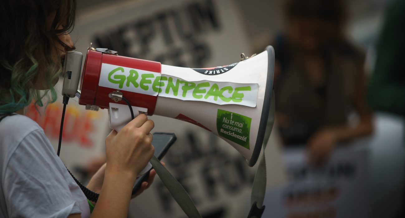 Greenpeace protest display showing activists with banners