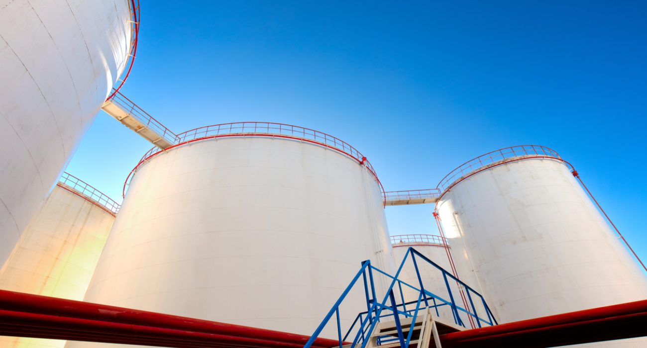 Oil storage tanks and pipelines at an industrial petroleum storage facility.