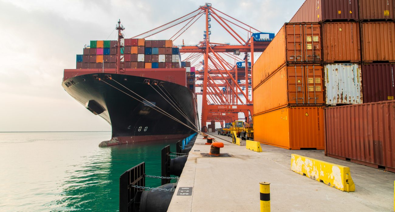 Container ship loading cargo at port terminal
