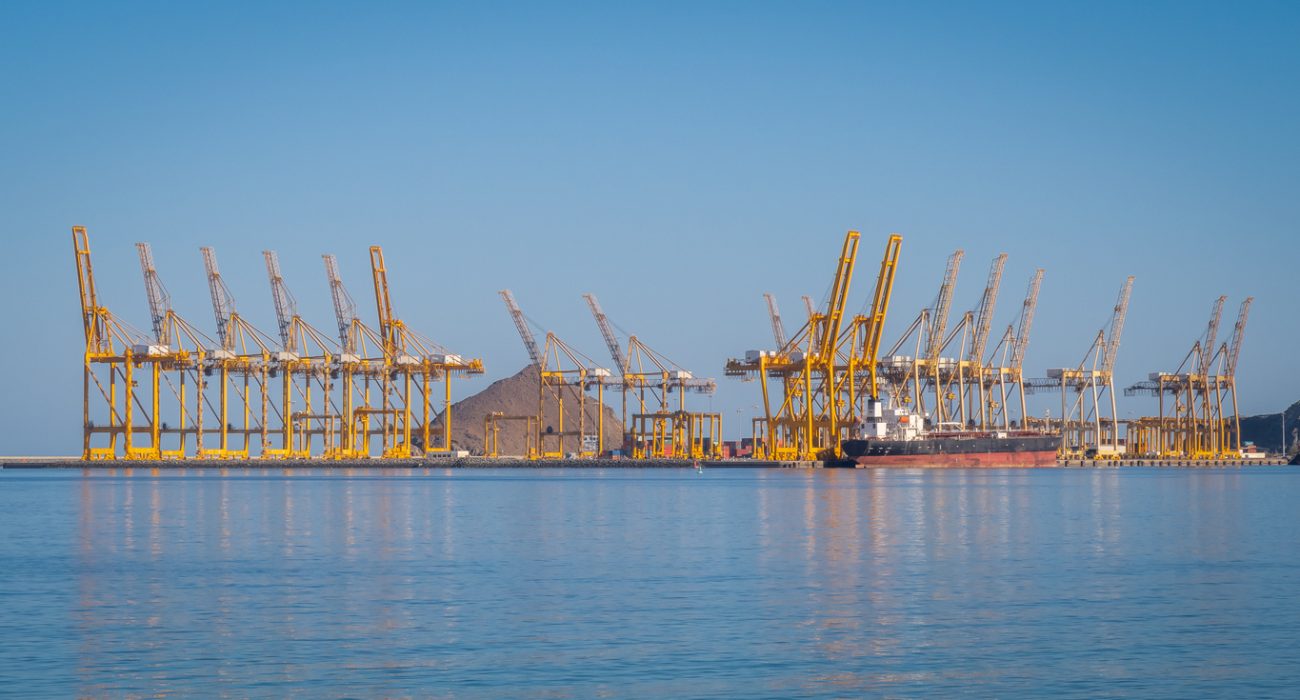 Port cranes loading a container ship at the Port of Fujairah UAE major Gulf shipping hub
