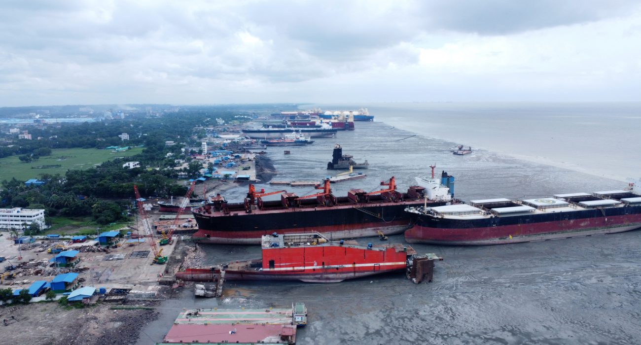 Ship recycling workers dismantling vessel at Bangladesh shipbreaking yard