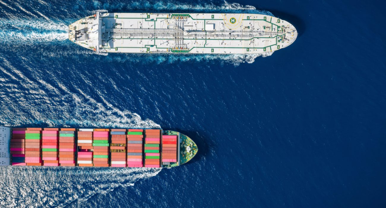 Container ship and crude oil tanker crossing at sea on international maritime shipping routes.