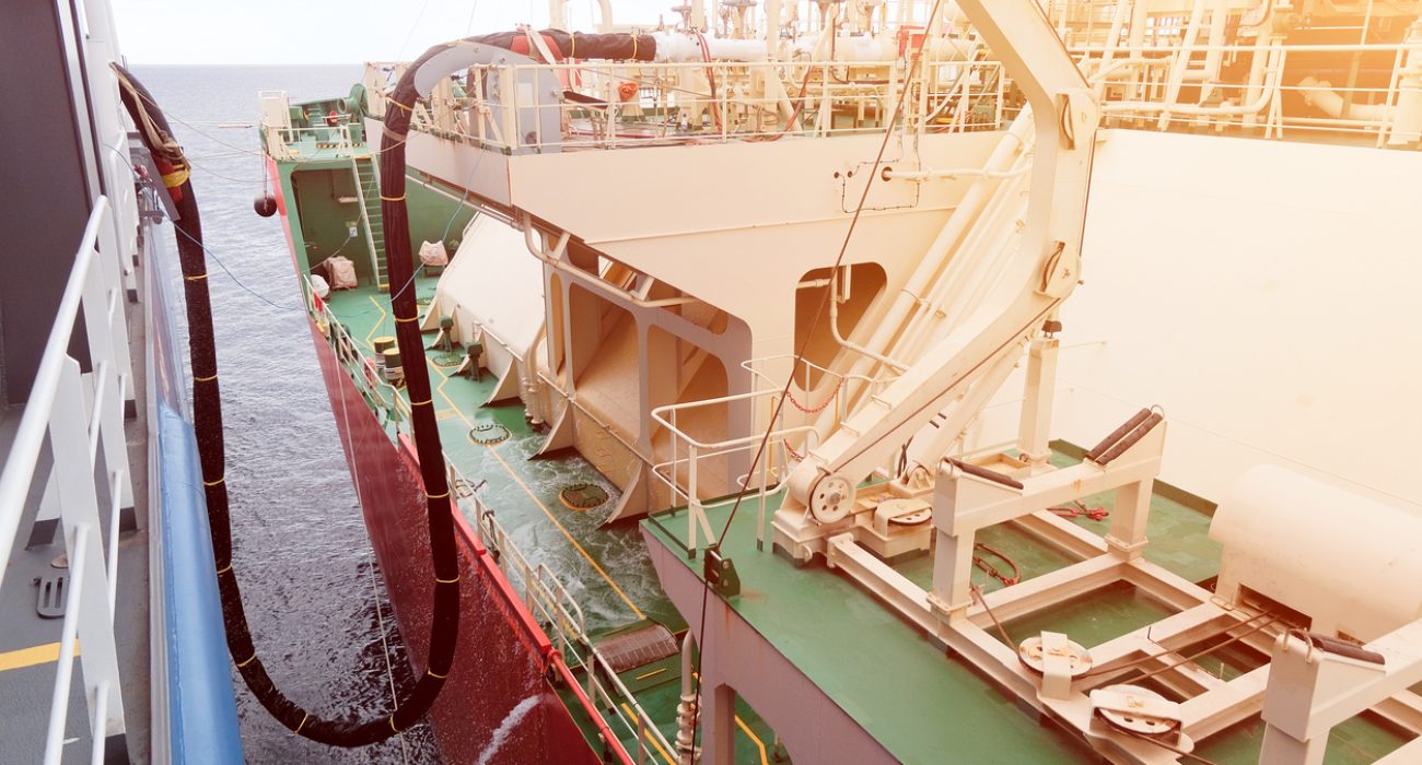 Ship to ship LNG bunkering transfer between tanker and LNG powered vessel at sea.