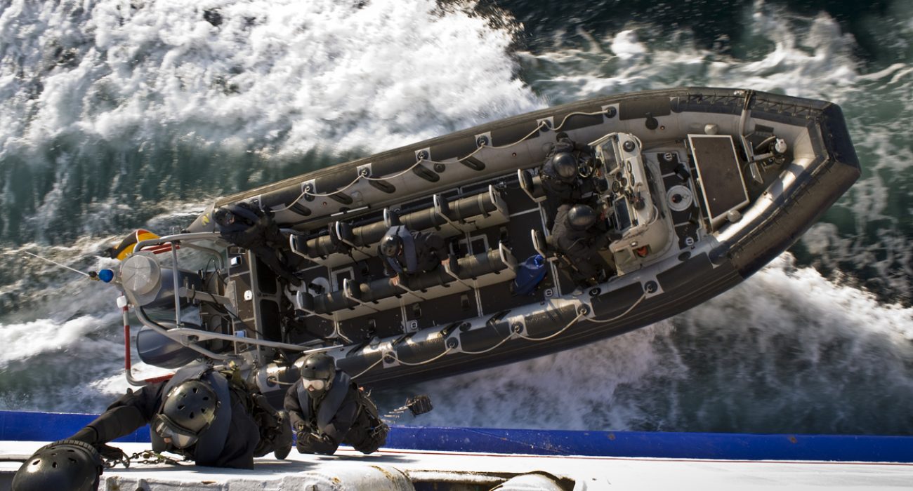 Naval boarding team approaches a vessel by RHIB during offshore maritime interdiction operation