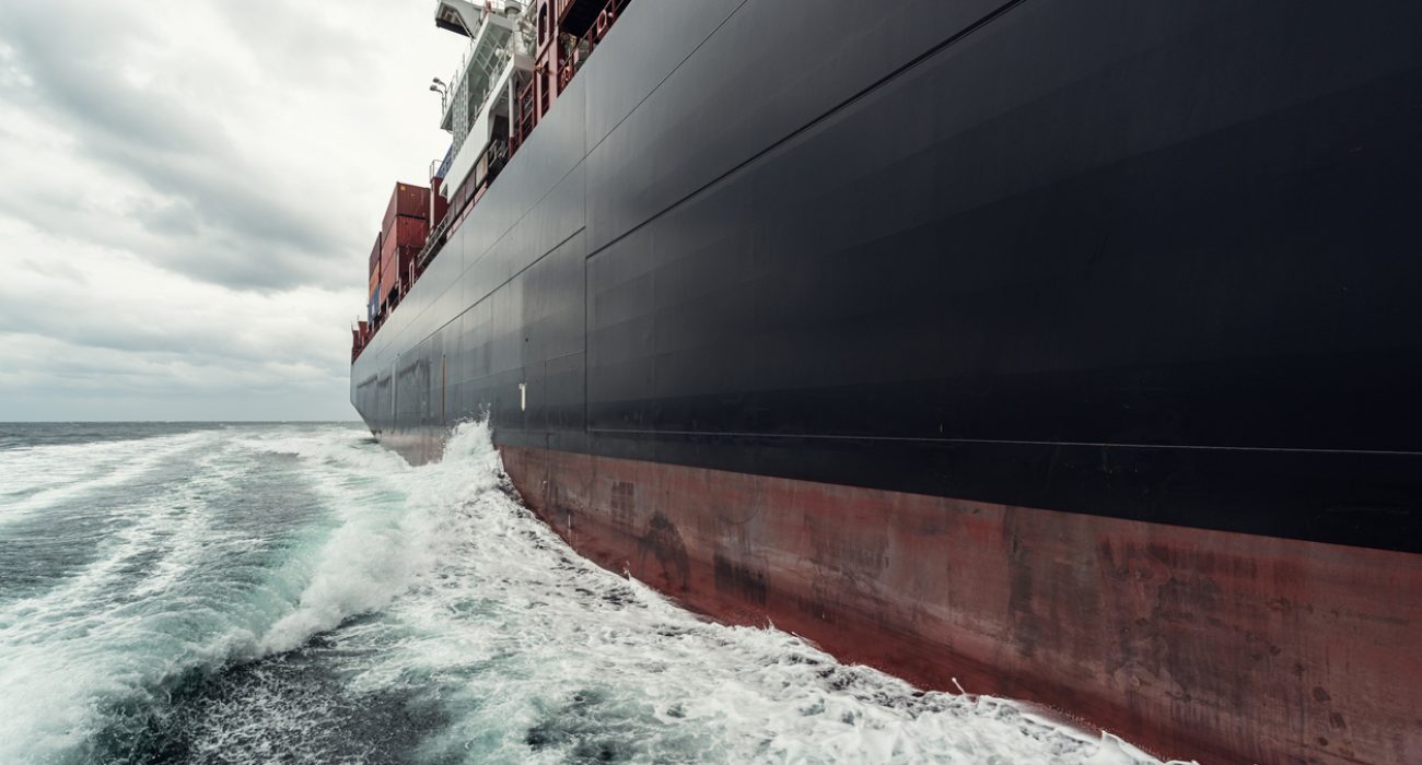 Container ship loaded with cargo containers sailing at sea on a global trade route.
