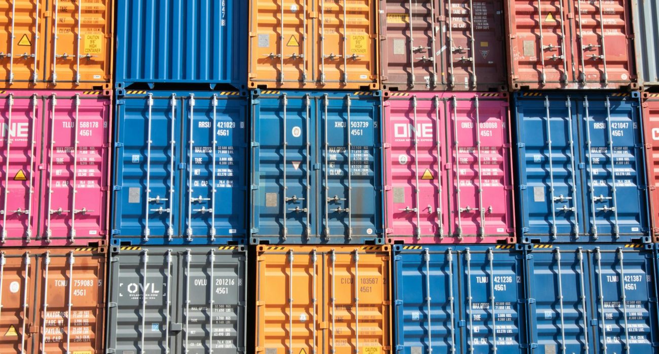 Stacks of multicolored shipping containers at a port