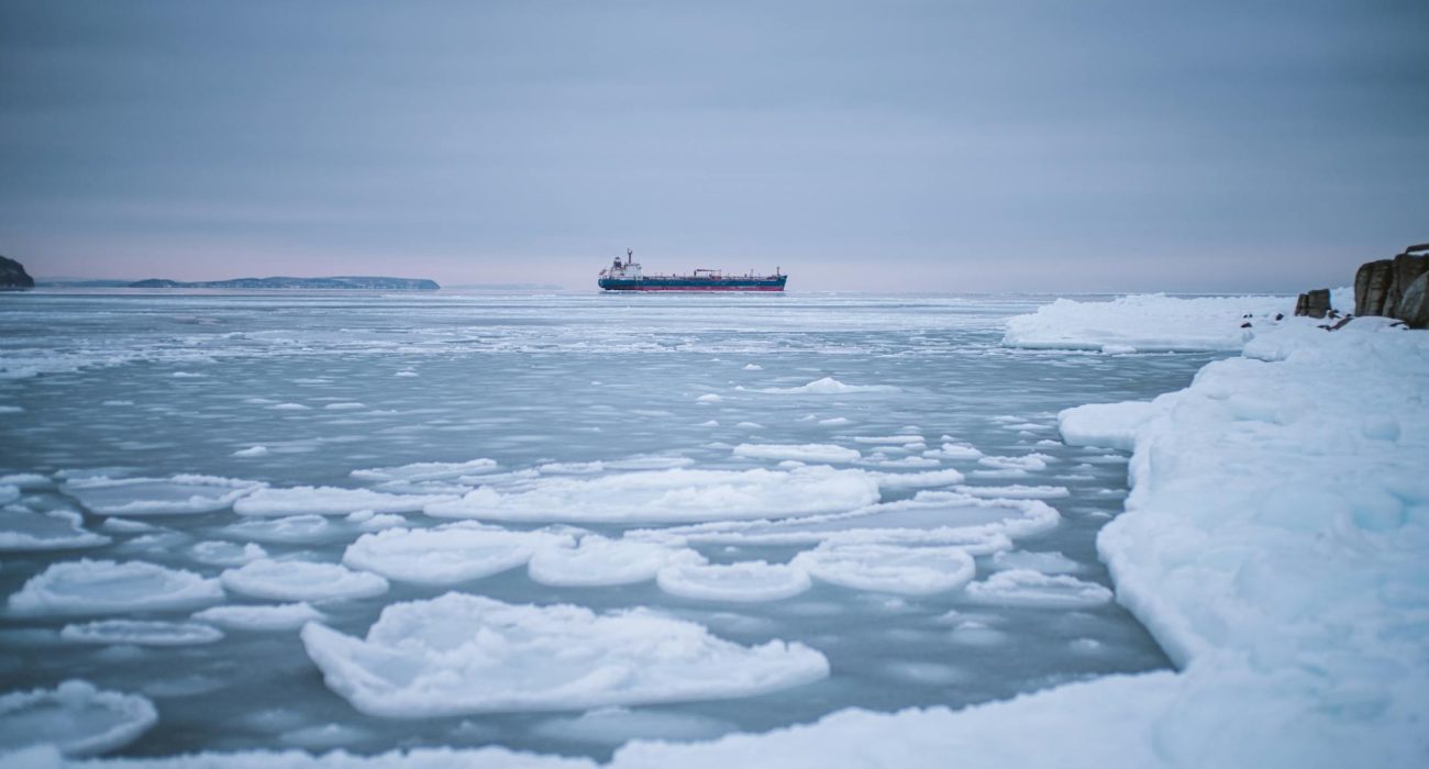 Melting Arctic iceberg and ice field representing changing northern maritime conditions